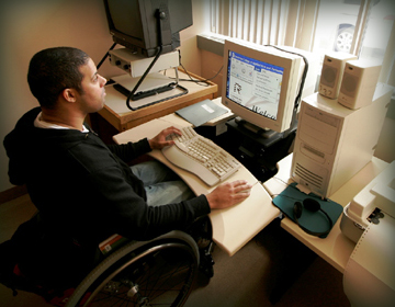 Student in wheelchair at computer.