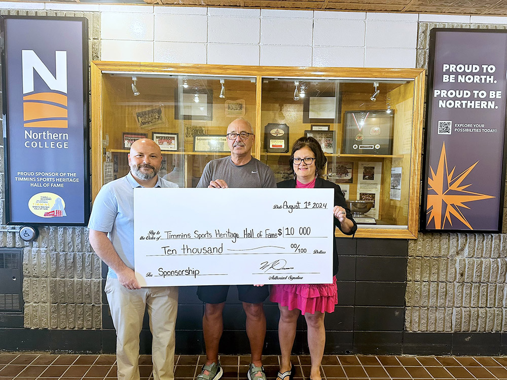 2 Northern College Staff holding a cheque for the donation 