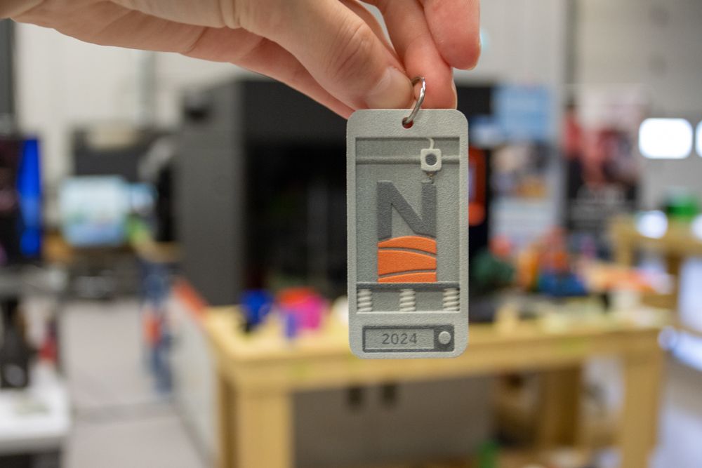 3d printed keychain with northern college logo