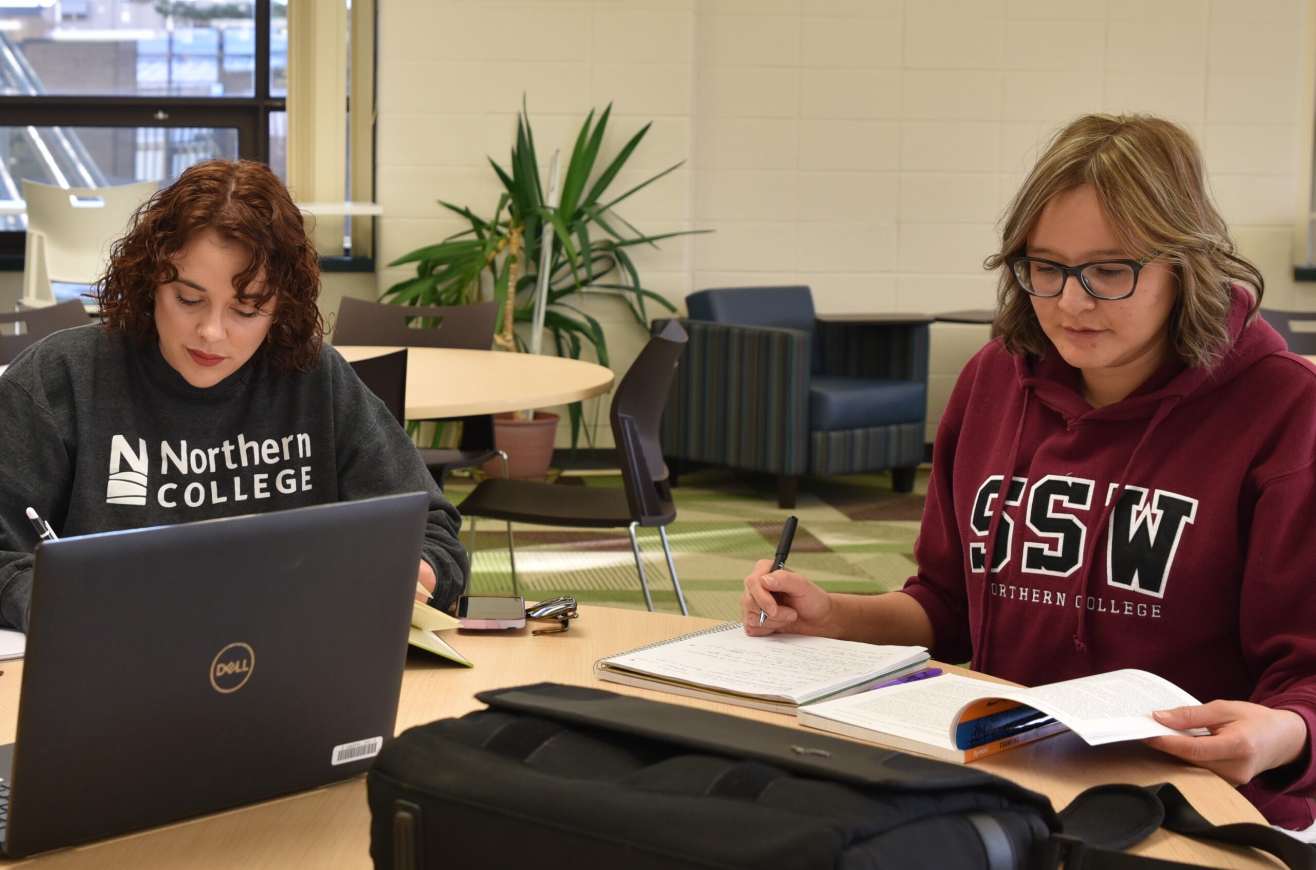 Social Service Worker student studying in library with friend at Northern College