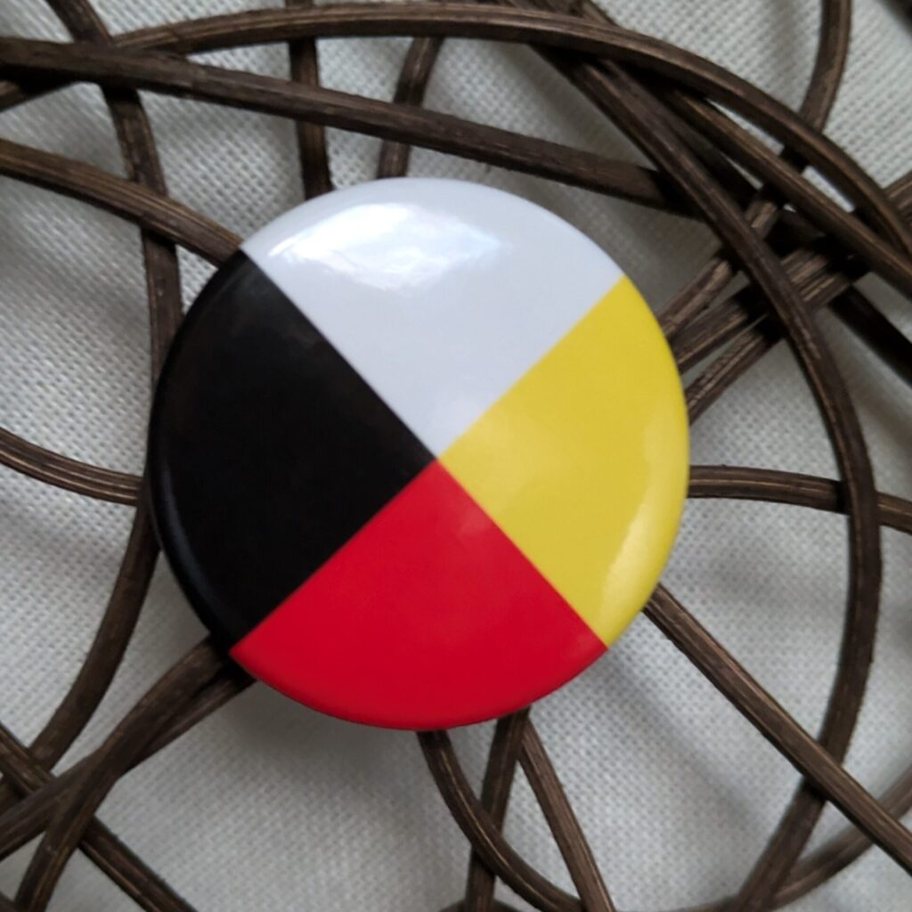 medicine wheel pin attached to woven decoration