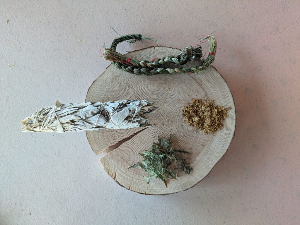 the four sacred medicines laid on to wooden plate