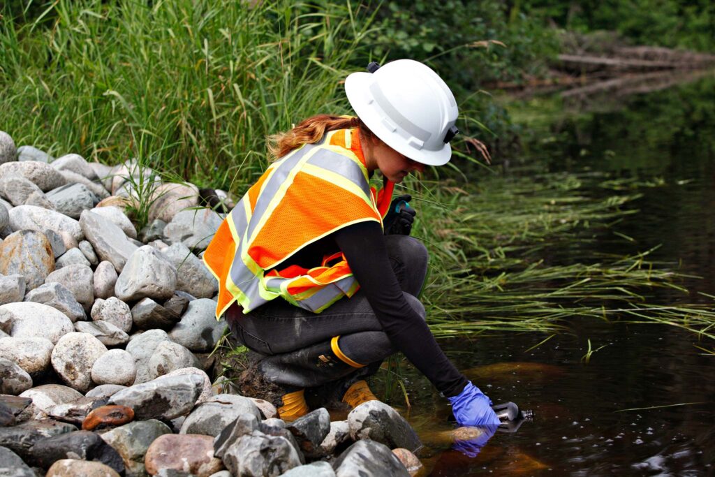 Environmental water wastewater student taking samples outside