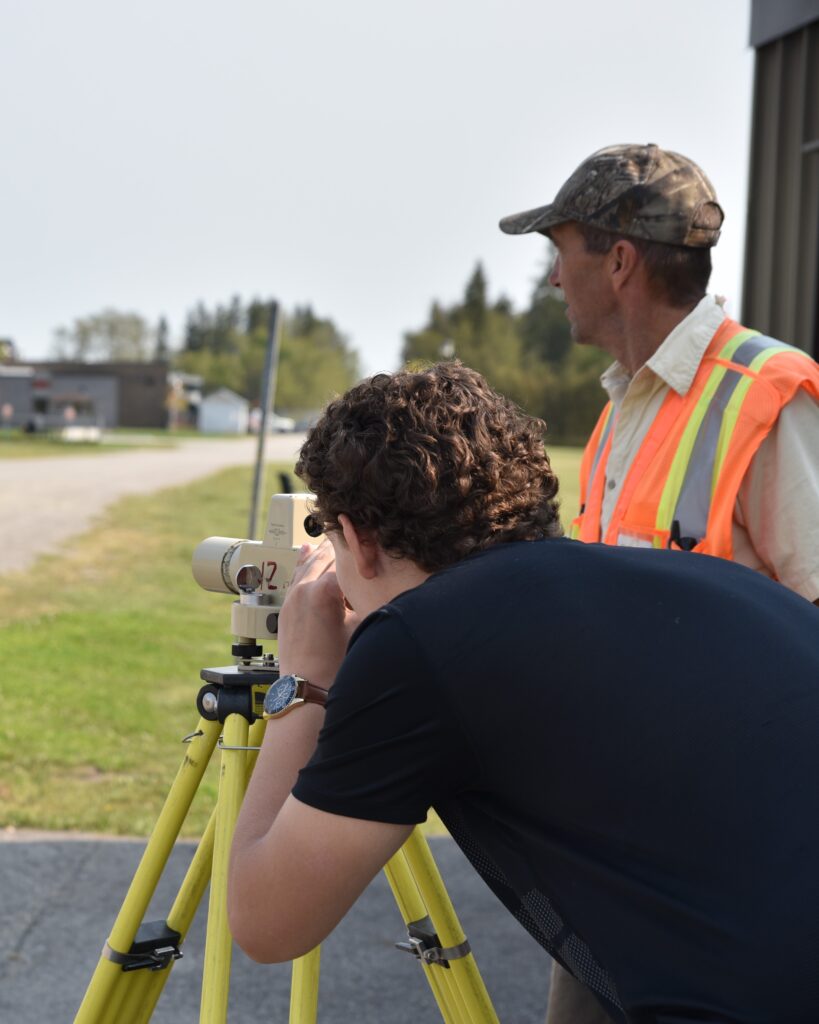 engineering technician student with instructor in surveying class